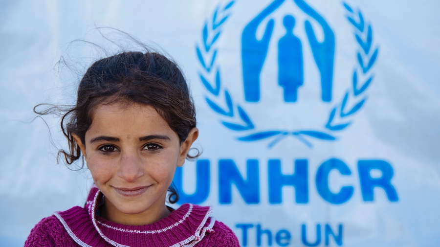 small girl with the UNHCR logo in the back. small girl with the UNHCR logo in the back.
